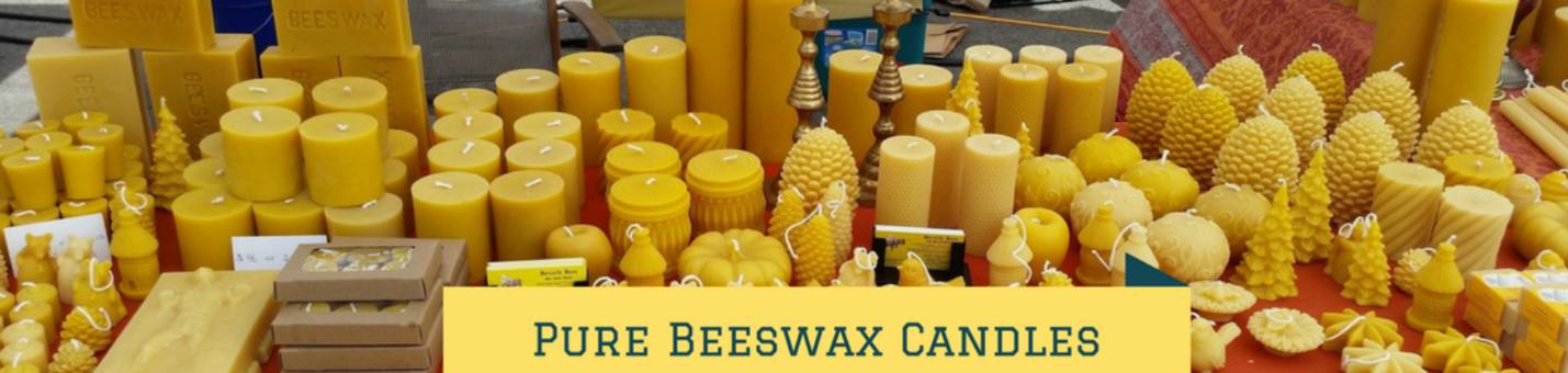 Selection of PURE BEESWAS CANDLES FROM A TRUSTED SOURCE displayed on a market table.